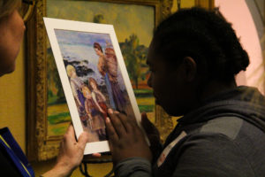 At the Barnes Foundation, a student from Overbrook School for the Blind feels the raised texture of a reproduction of an impressionist painting that has been outlined in glue.