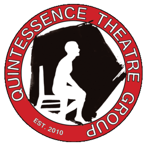 Quintessence Theatre Group Logo: Red circular banner reads Quintessence Theatre Group, EST. 2010. Within circle is a rustic black pentagon with a white silhouette of a seated figure in a chair.