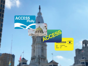 4 cards fan out overlay on blurred image of Philadelphia's City Hall. Top card: Art-Reach ACCESS Philly Card, PA State ACCESS Card with PA Capitol & Cherry Blossoms, Blue Green ACCESS PA ACCESS Card, Yellow PA State ACCESS Card for Medical Benefits