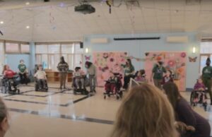 a classroom performance by students in wheelchairs and their supporting staff